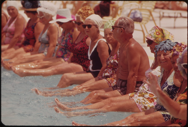 Residents of the Century Village Retirement Community Gather Around Pool for Daily Exercise Session.