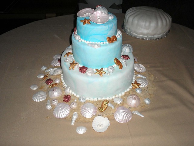 Beachtheme Wedding Cake A threetiered chocolate cake covered in marbled 