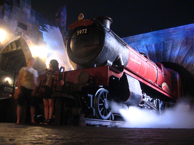 Hogwarts Express billows steam at night in the Wizarding World of Harry Potter