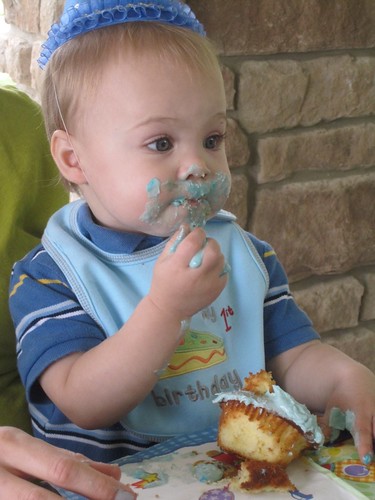 Baby eating first birthday cake 
