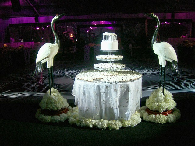 Black and White Themed Wedding Cake Table Decorated With All White Fresh