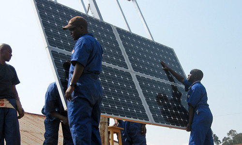 Training workers to install solar panels at health clinics in Rwanda provides clean energy, creates jobs, and improves health service delivery.