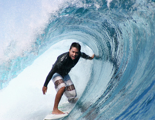 Pro-surfer Dennis Tihara surfing a tube at Teahupoo, Tahiti.