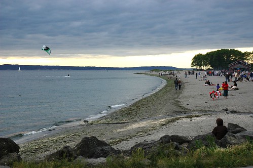 Kite surfing, gray overcast warm summer evening, Golden Gardens park, Seattle, Washington, USA by Wonderlane