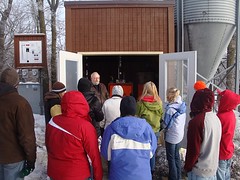 A tour group learns about the biomass boiler - click for larger image