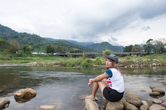 NAKHONSRITAMMARAT,THAILAND-JAN 17,2016 :  The girl sitting on the rock in Kiriwong village,Attractions with good weather and a beautiful view at Nakhonsritammarat , thailand on 17 january 2016
