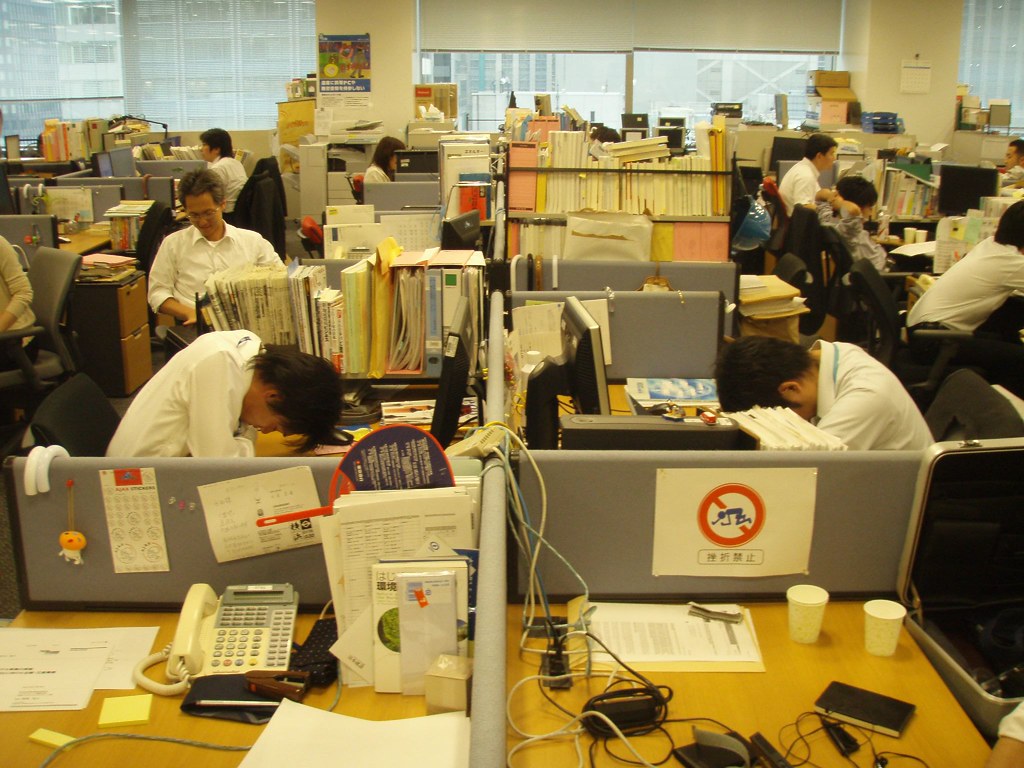 Overworked Workers sleep in their office