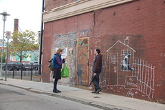 Banksy in Boston: Visitors getting photos with the NO LOITRIN piece on Essex St in Central Square, Cambridge