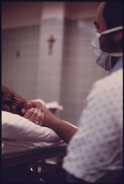 A Husband Holds His Wife's Hand During Delivery of Their Baby in Loretto Hospital in New Ulm, Minnesota... from Flickr via Wylio