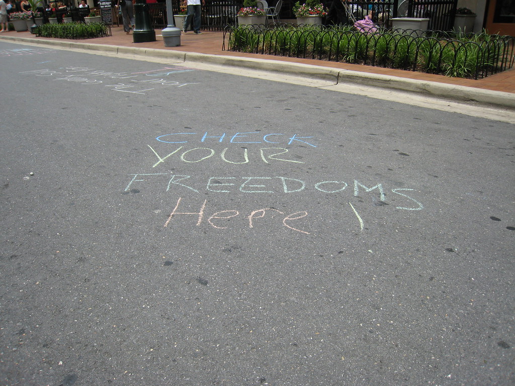 chalk that says "check your freedoms here"