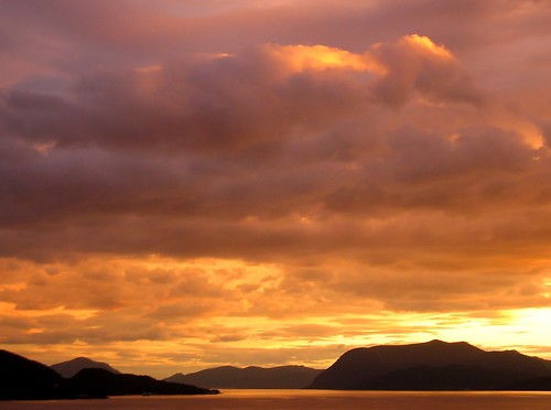pink sunset sea sky orange sun mountains color nature yellow clouds landscape warm horizon peach fjord