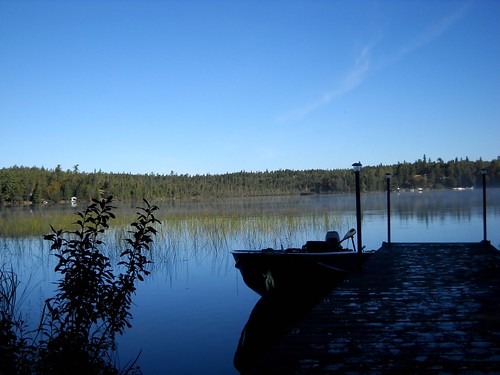 blue sky lake reflection reeds boat dock cabin cottage granitelake
