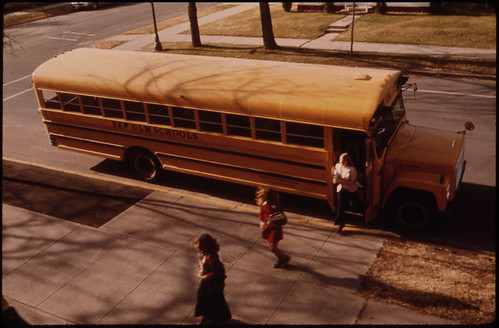 Students Arriving by Schoolbus at Cathedral Senior High School in New Ulm, Minnesota...