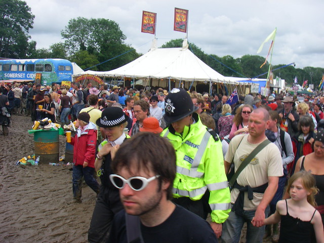 Polict walking through crowds atfestival