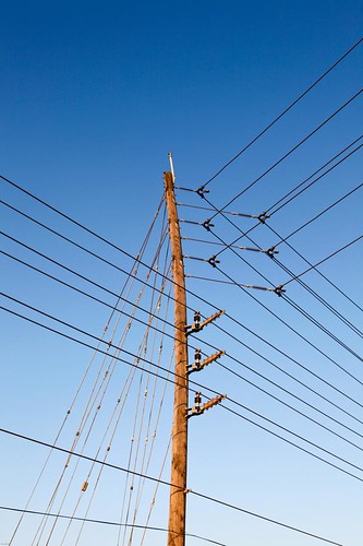 sunset golden wire telephone pole bent highvoltage asunsetwalkalongthepowergridanddisributionsystemnearhome