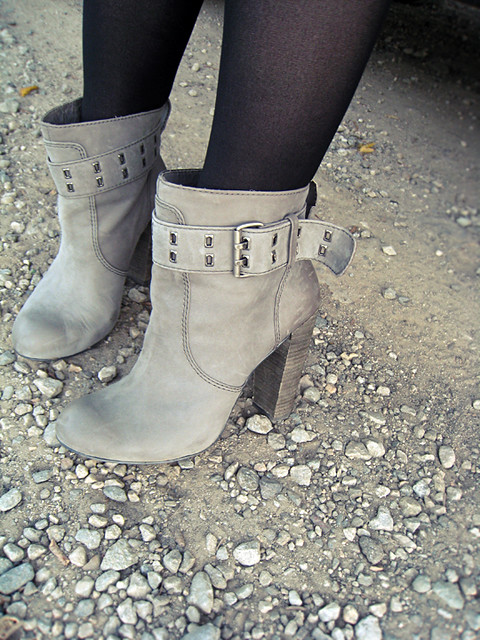 gray ankle boots on rocks