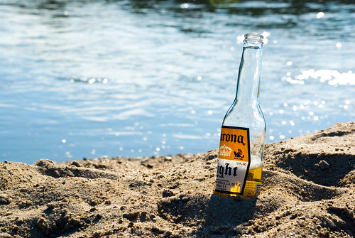 sunset beach water beer bottle sand corona