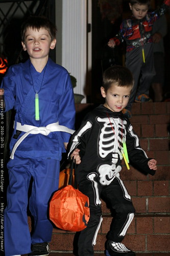 marcus, nick and sequoia leaving a house with their candy in hand