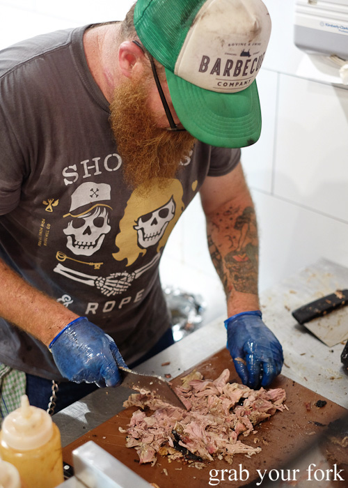 Wes Griffiths chopping up barbecued pork at Bovine & Swine, Enmore Sydney food blog review