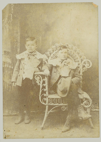 Two children and a wicker chair