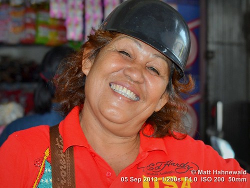 indoor market cultural character adult ethnic portrait smiling crashhelmet teeth posing primelens consent respect authentic red closeup street tiltedhead eyes asia flash matthahnewaldphotography face facingtheworld horizontal head indonesia indonesian nikond3100 singkawang southeastasia travel westkalimantan 50mm oneperson expression headshot nikkorafs50mmf18g fullfaceview 4x3ratio 1200x900pixels resized lookingatcamera colourful colour