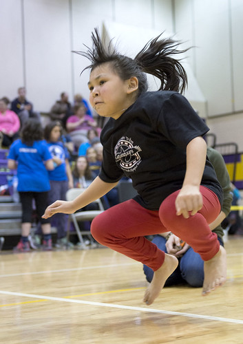 Kenaitze's Abby Seamen heads to her feet in the kneel jump event Saturday. Athletes have to go from kneeling on their knees to a standing position without using their hands or taking a step to balance themselves.