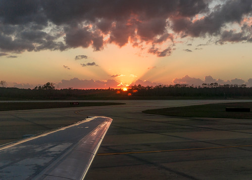 trees sunset sun southwest clouds airplane outdoors airport wing jacksonville jax runway 737