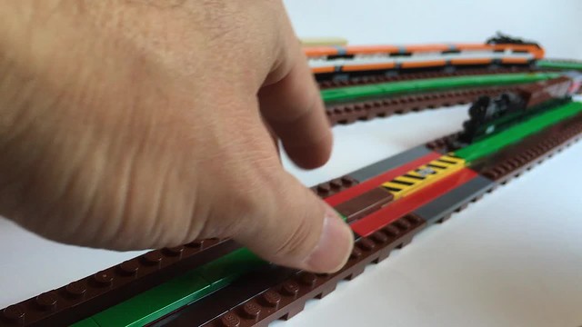 One stud wide trains: articulated magnetic coupling, flexible magnetic track, and track switch.