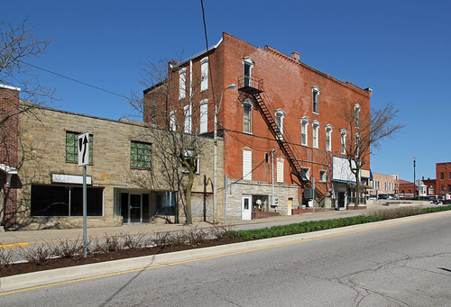 county street blue windows sky building brick altered buildings fire escape structures indiana 11 structure historic sidewalk cables commercial wires storefronts median slope angola steuben remodeled hoodmolds corbelled corbelling threestory imitationstone