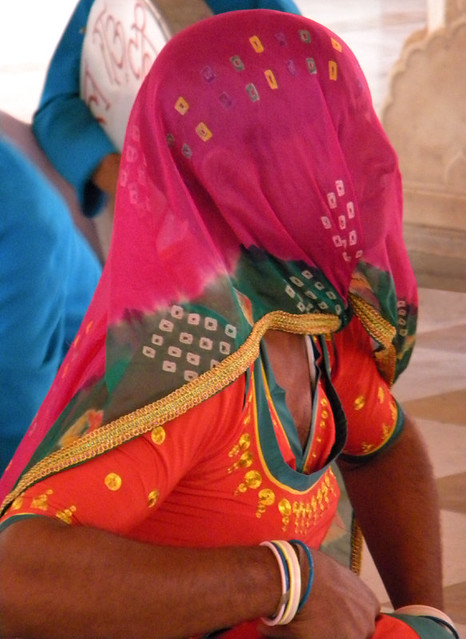 A male dancer impersonating a veiled female dancer at the Jaipur Palace of the Winds in Jaipur, India