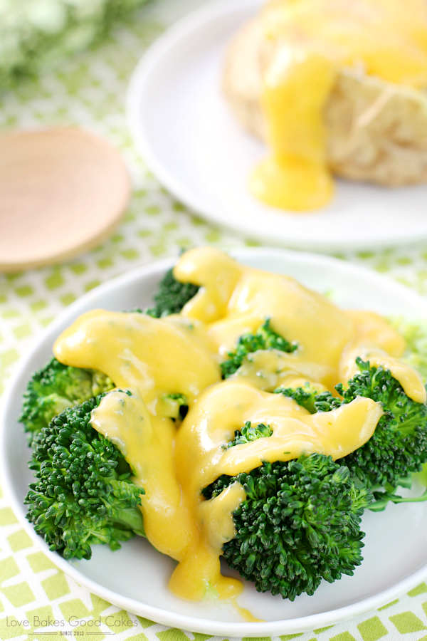 Basic Cheese Sauce over broccoli on a plate.