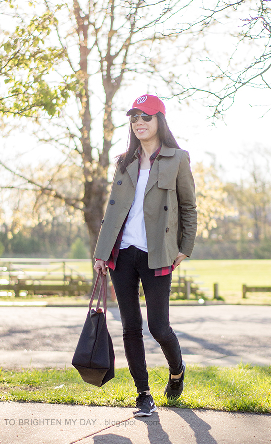 red baseball cap, green swing trench, plaid button up shirt, black sneakers