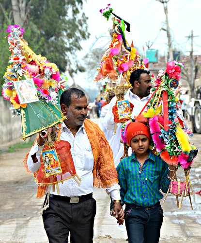 Hindu devotees carry decorated floats on an annual pilgrimmage to a Maha Shivaratri festival to honour Lord Shiva