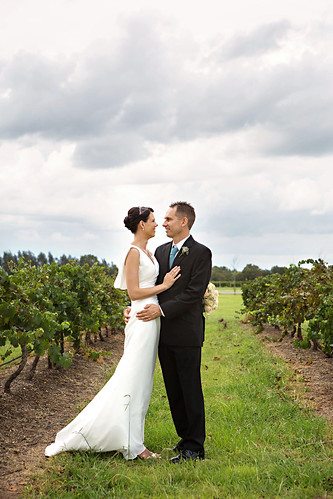 The bride and groom amongst the vineyards.