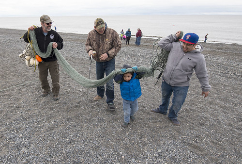 George Showalter, Aazaiah Barbaza and Ryan Williams carry the net back up the beach with Aazaiah's dad Art Barbaza.