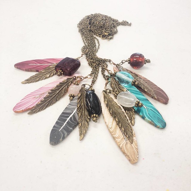 The first round of feather necklaces! Glass and stone mixed with antique brass tones. #polymerclay #beads #handmade #jewelrymaking #necklaces