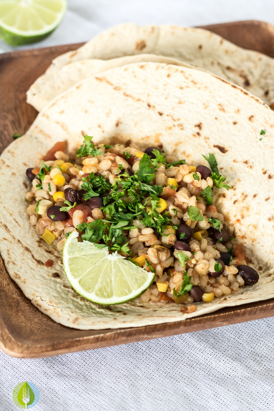 soft taco shell filled with vegan black bean and barley filling