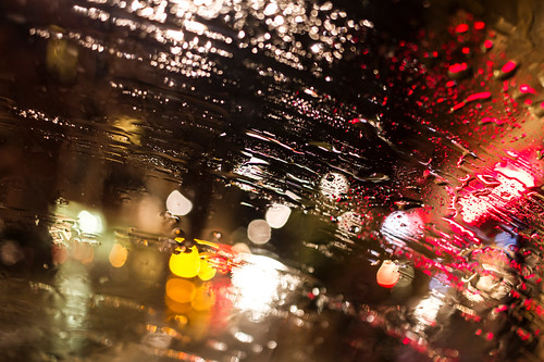 Abstract view onto city lights through a car windshield