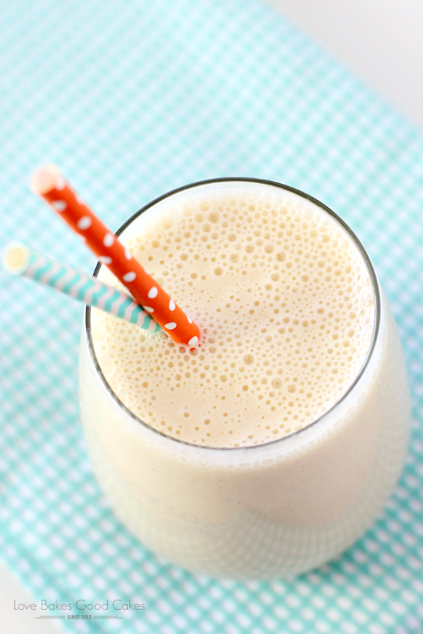 Peach-Banana Oatmeal Smoothie in a glass with a straw close up.