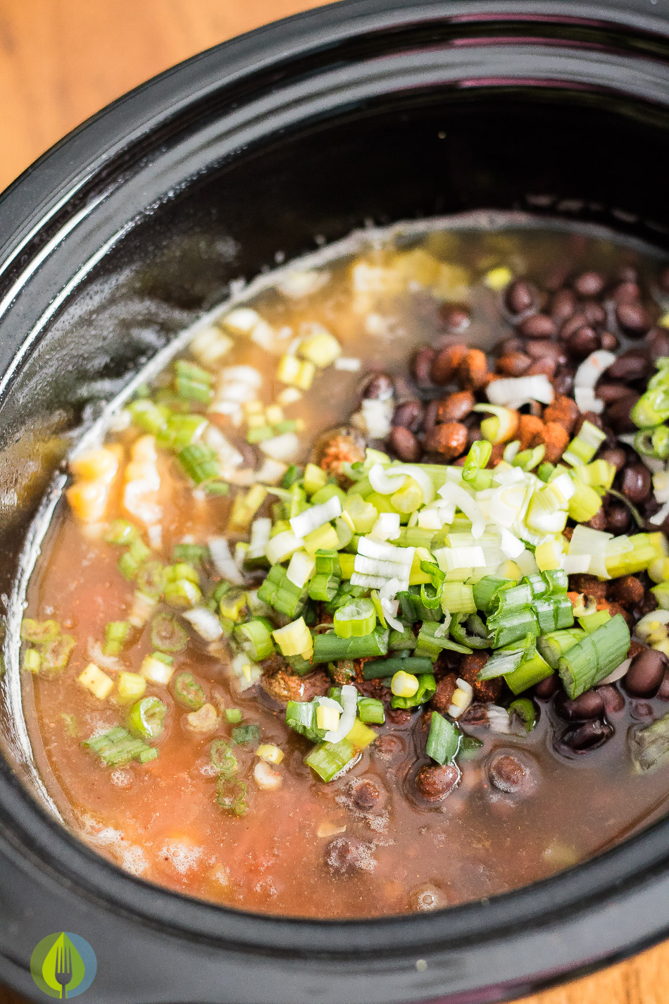 slowcooker filled with ingredients to make barley and blackbean burritos
