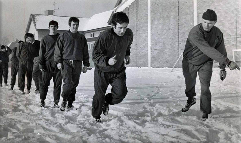 Colin Harvey and some of his Everton teammates are put through their paces despite a heavy covering of snow at the training ground.