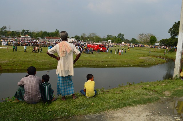 A man watches a Congress rally from a distance in Jania