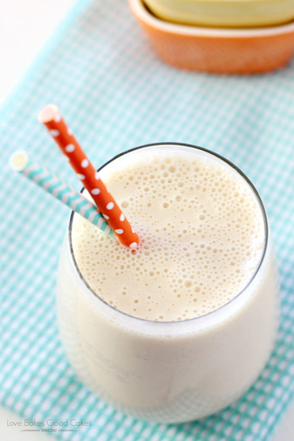 Peach-Banana Oatmeal Smoothie in a glass with a straw.