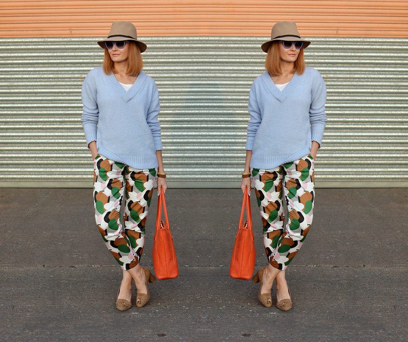 Spring style: Bold patterned pants, pale knit, orange tote, camel fedora | Not Dressed As Lamb