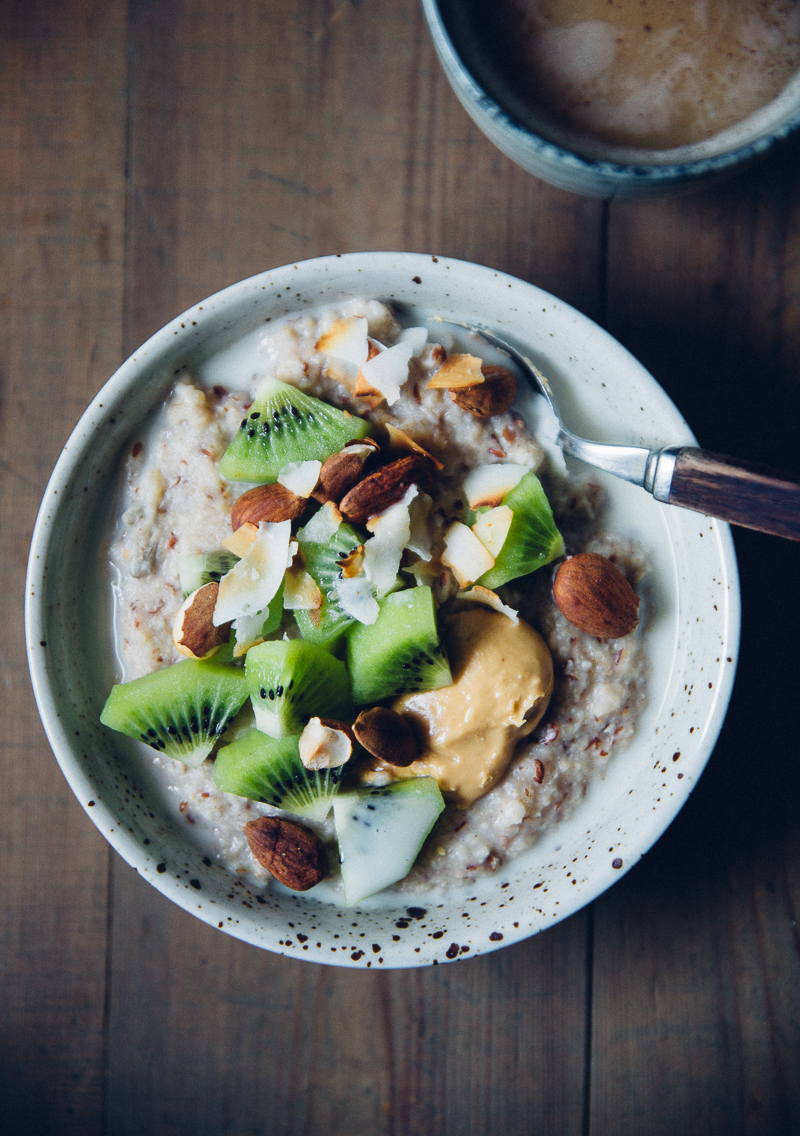 Millet Porridge with kiwi, peanut butter, almonds & toasted coconut - quick to assemble on busy Monday mornings | Cashew Kitchen