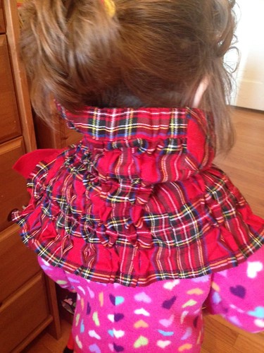 Tartan skirt becomes a scarf using tuck and fold stich