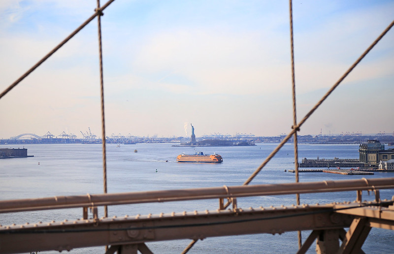 statue of liberty view from brooklyn bridge