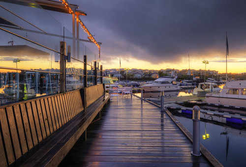 houses homes sunset sky wet glass rain clouds marina reflections bench landscape boats lights restaurant shadows chairs cloudy sweden stockholm outdoor furniture flag rainy tables boardwalk sverige lamps yachts raining hdr lidingö gåshaga gåshagabrygga gåshagamarina restaurangbryggan