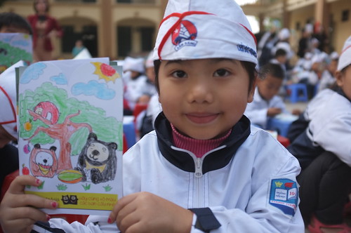 A little girl shows her beautiful drawing of bears
