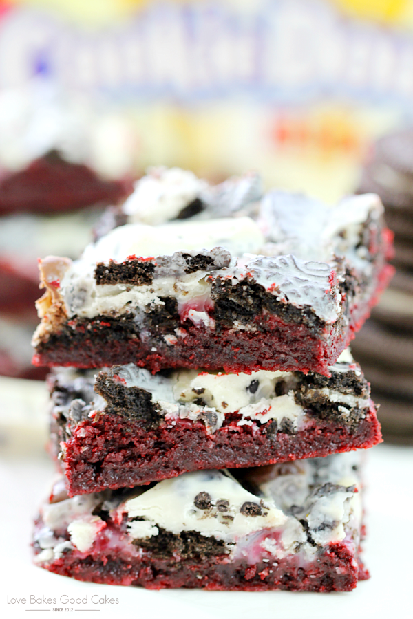 Cookie Lover's Red Velvet Bars stacked up on a plate.
